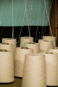 Photo by K15 Photos selective focus photography of white threads