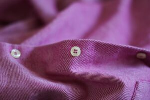Photo by Evgeniya Shustikova purple textile with white button