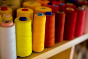 Photo by Jas Min red blue yellow and orange rolled thread