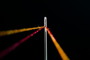 Photo by amirali mirhashemian red and yellow thread in needle